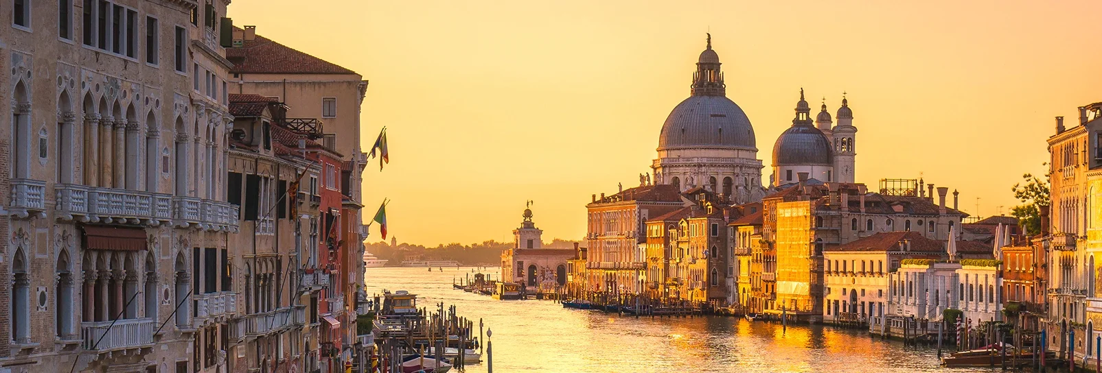 Venice canal and historic buildings at golden hour